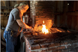 Blacksmith at forge[315]