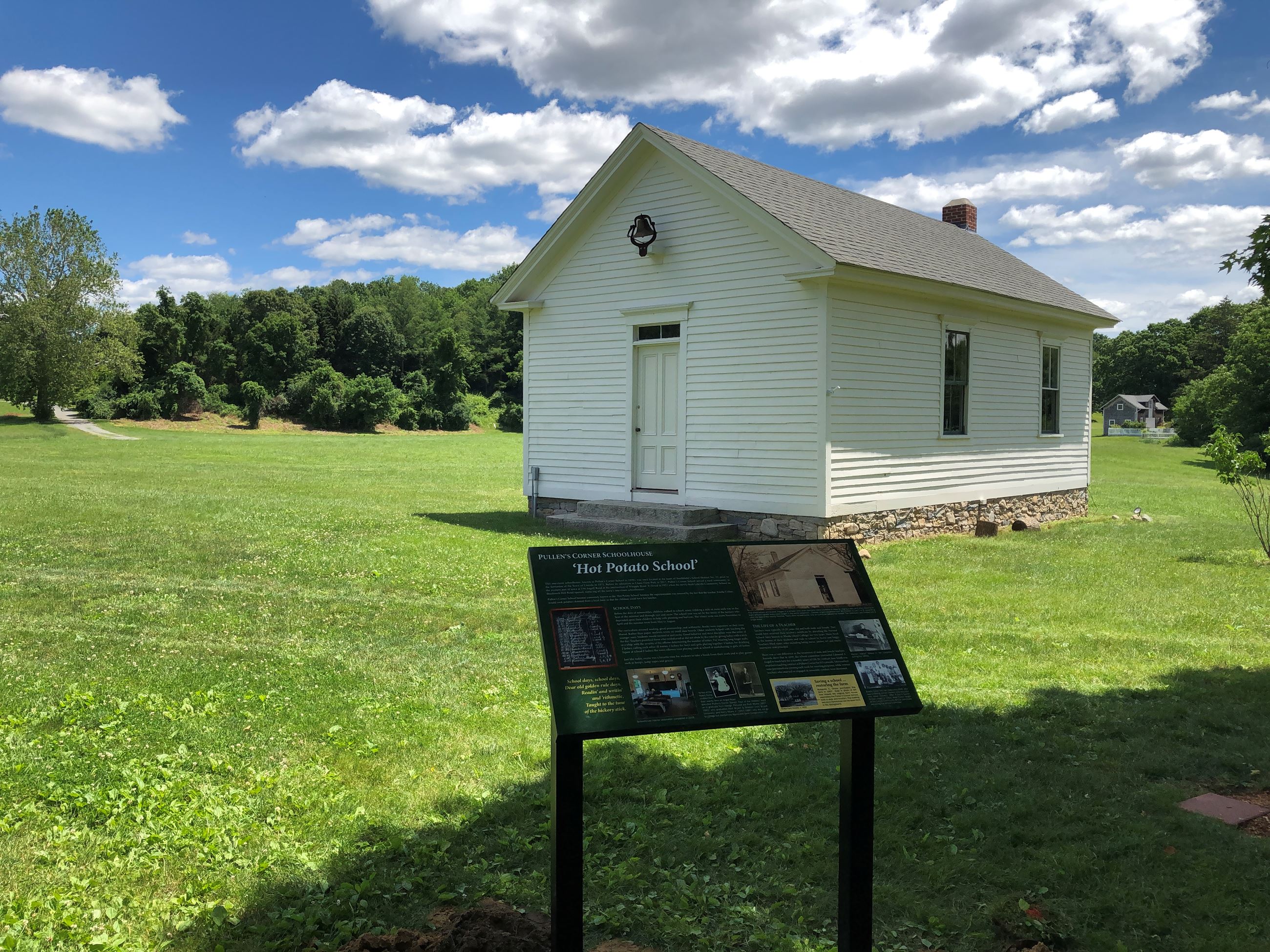 Schoolhouse sign and hills[323]